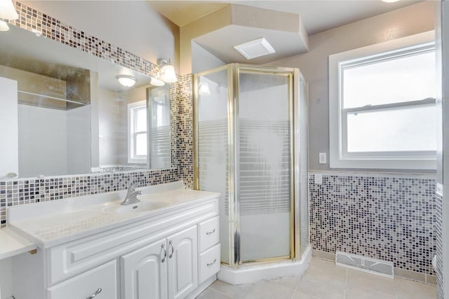 bathroom featuring vanity, an enclosed shower, tile patterned flooring, and tile walls