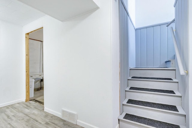 stairs with wood-type flooring