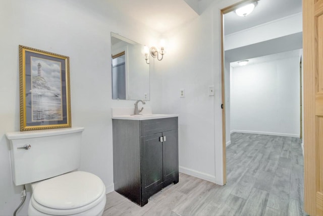 bathroom featuring hardwood / wood-style flooring, vanity, and toilet