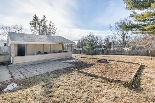 view of yard with a sunroom and a patio