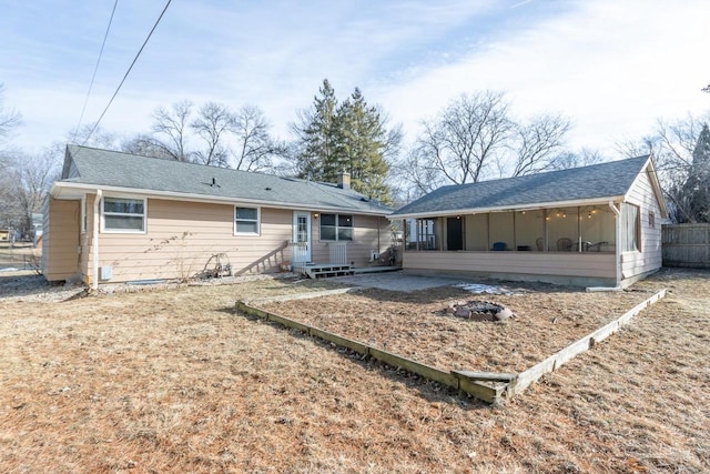 rear view of house featuring a sunroom