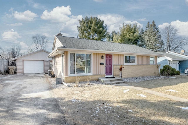 ranch-style house featuring an outbuilding and a garage