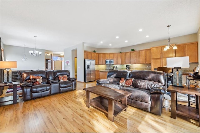 living room with light hardwood / wood-style floors and a chandelier