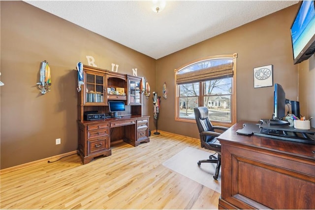 office with a textured ceiling and light hardwood / wood-style floors