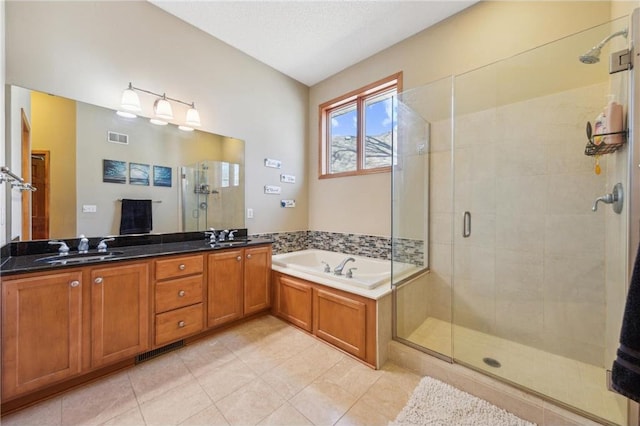 bathroom with vanity, independent shower and bath, and tile patterned flooring