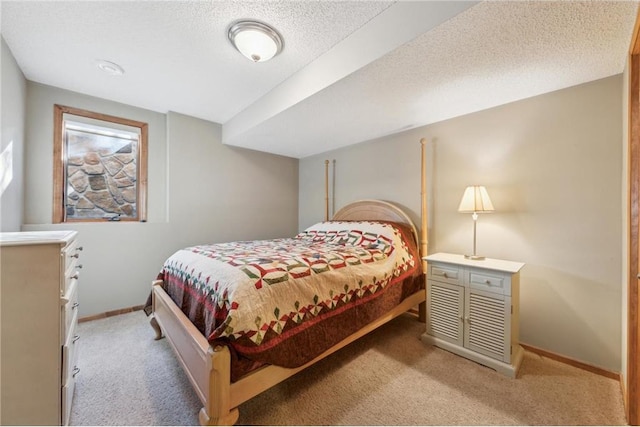 bedroom featuring light carpet and a textured ceiling