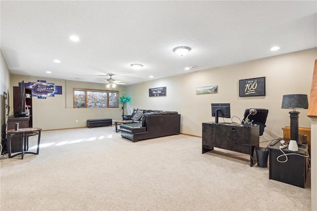 carpeted living room featuring ceiling fan and a textured ceiling