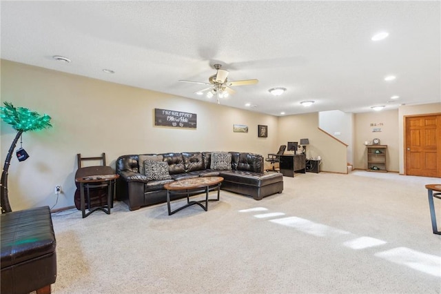 living room featuring light carpet, a textured ceiling, and ceiling fan