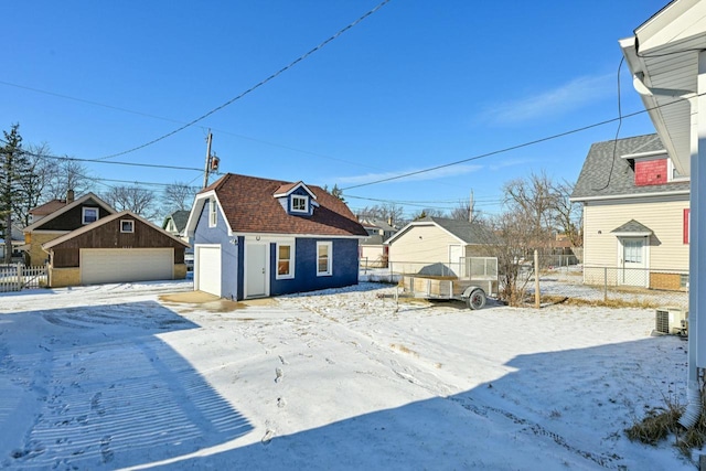 view of front of home with a garage and an outdoor structure