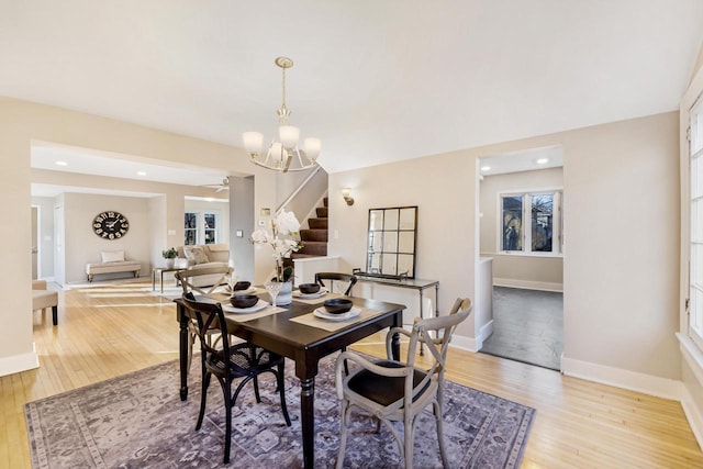 dining space featuring light hardwood / wood-style flooring and a chandelier