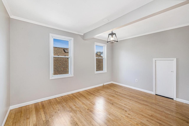 unfurnished room featuring crown molding, hardwood / wood-style floors, and beam ceiling