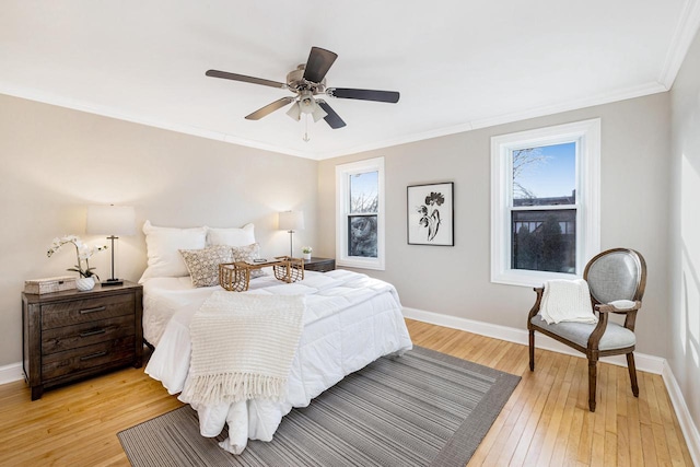 bedroom featuring multiple windows, ornamental molding, and light hardwood / wood-style flooring