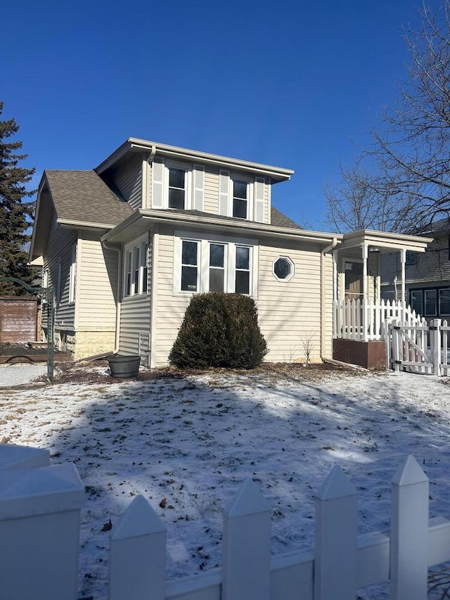 snow covered property featuring a sunroom