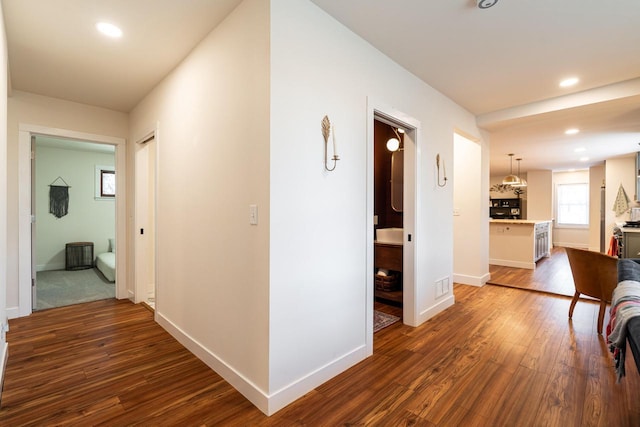 hallway featuring dark hardwood / wood-style flooring