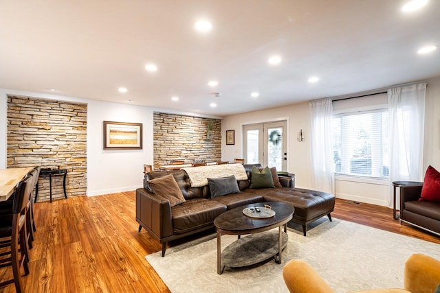 living room featuring french doors and light hardwood / wood-style flooring