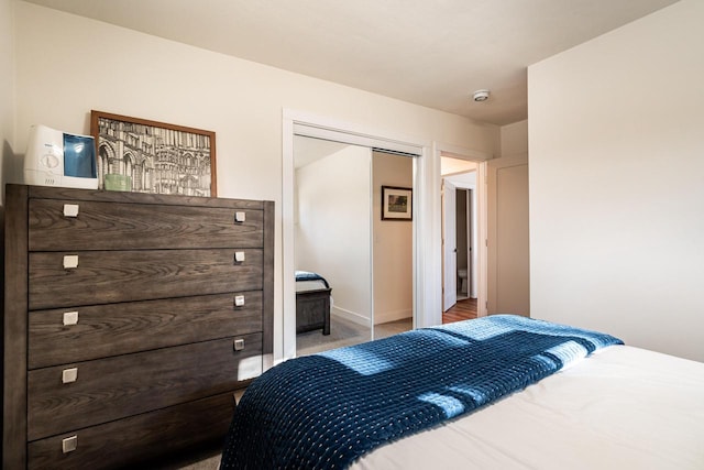 bedroom featuring a closet and light carpet