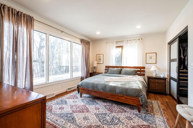 bedroom featuring a closet and dark hardwood / wood-style floors