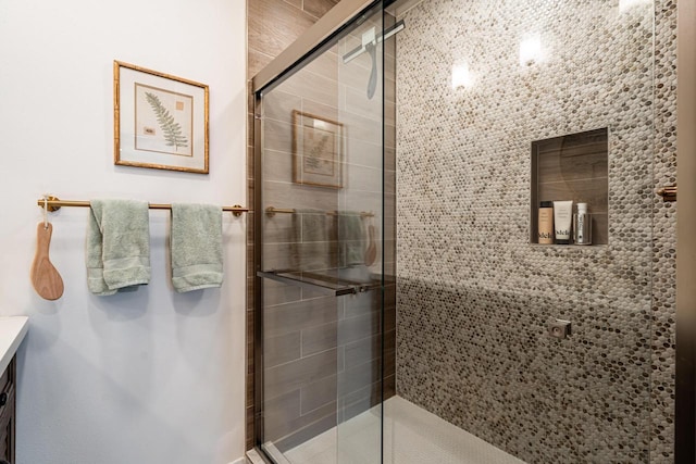 bathroom featuring a shower with shower door