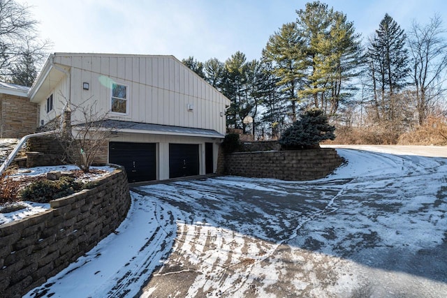 snow covered property featuring a garage