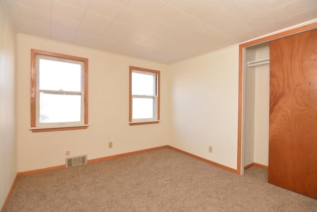 unfurnished bedroom featuring a closet and carpet flooring