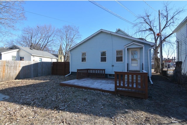 back of house featuring a wooden deck