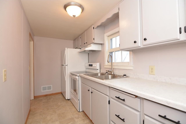 kitchen with sink, white appliances, and white cabinetry