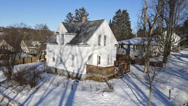 view of snowy exterior featuring a wooden deck