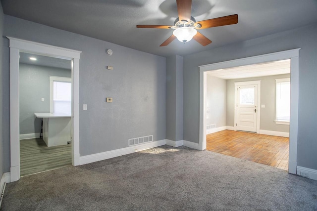 spare room with carpet flooring and ceiling fan