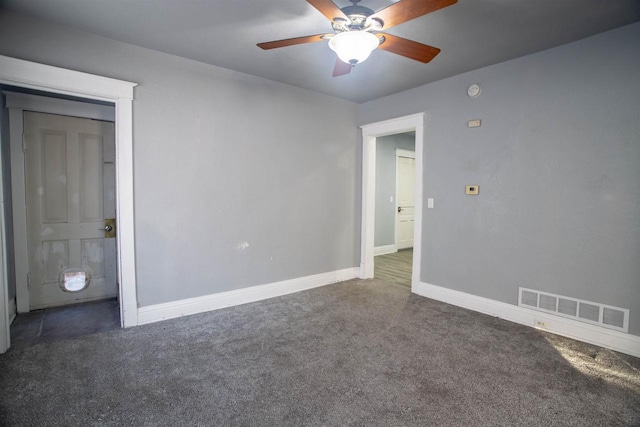 unfurnished bedroom featuring ceiling fan and dark colored carpet