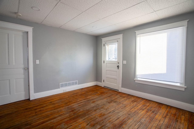 foyer featuring a paneled ceiling and dark wood-type flooring