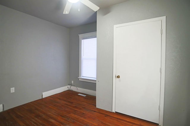 unfurnished bedroom with dark hardwood / wood-style floors and ceiling fan