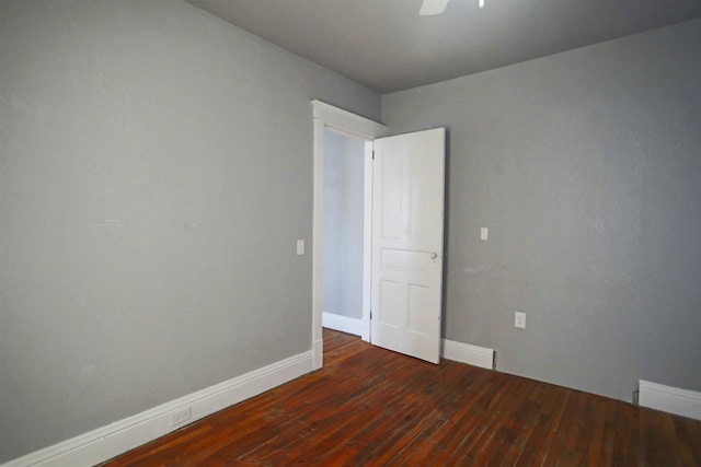 unfurnished room featuring ceiling fan and dark hardwood / wood-style flooring