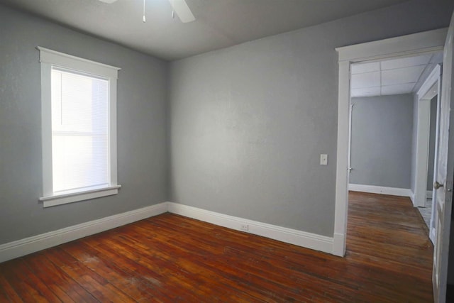 empty room featuring ceiling fan and dark hardwood / wood-style flooring