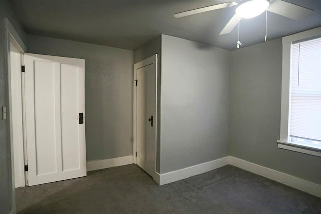 carpeted empty room with ceiling fan