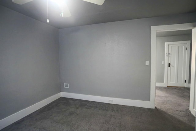 spare room featuring ceiling fan and dark carpet