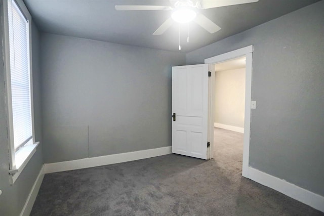 carpeted spare room with ceiling fan and a healthy amount of sunlight