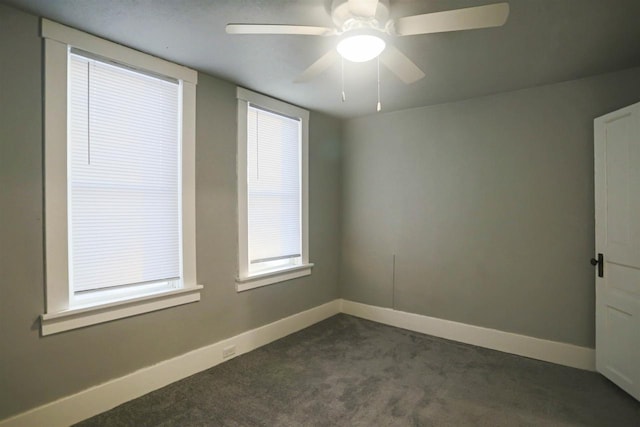 carpeted spare room with ceiling fan