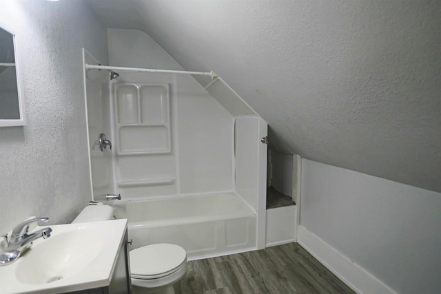 full bathroom with a textured ceiling, vanity, toilet, vaulted ceiling, and hardwood / wood-style flooring