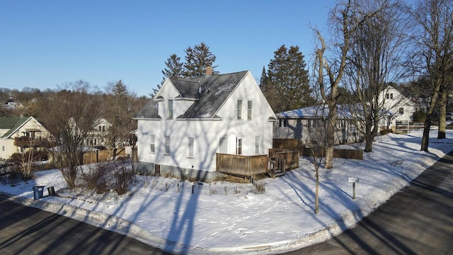 snow covered property with a wooden deck