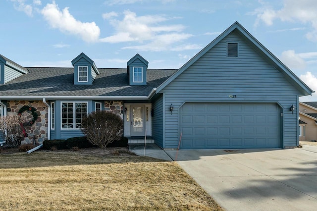 view of front of property with a garage and a front lawn