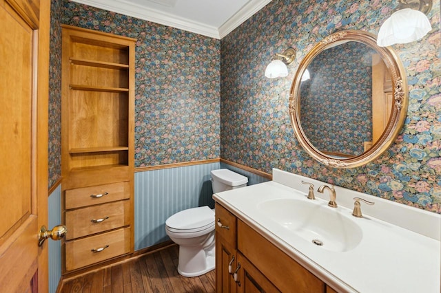 bathroom featuring ornamental molding, wood-type flooring, toilet, and vanity