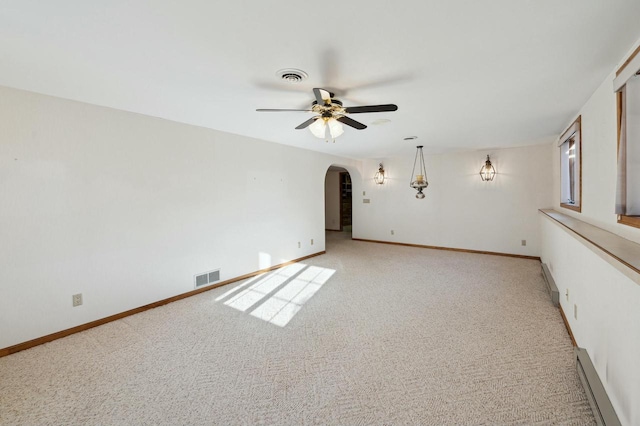 carpeted empty room featuring a baseboard radiator and ceiling fan