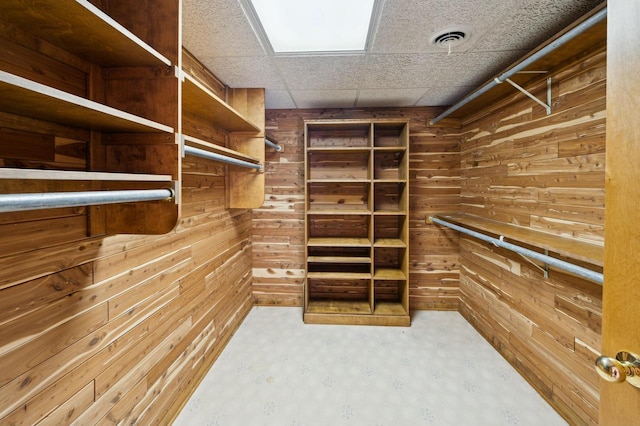 walk in closet with a drop ceiling