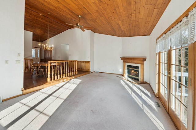 unfurnished living room with carpet flooring, wooden ceiling, and a chandelier