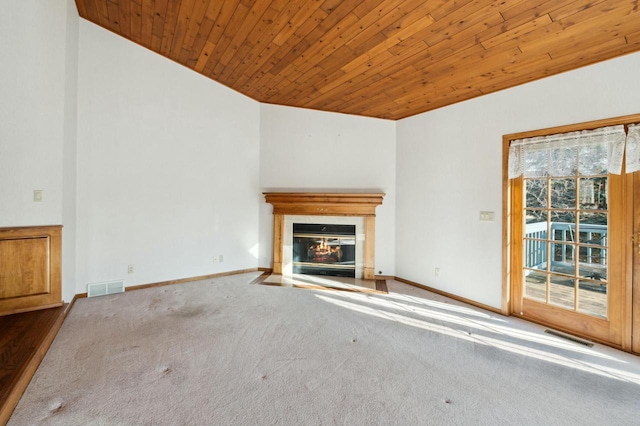 unfurnished living room with wood ceiling and carpet floors