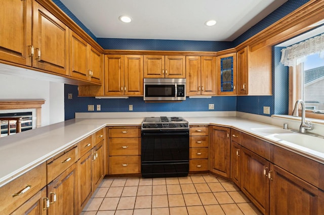 kitchen featuring light tile patterned flooring, sink, backsplash, kitchen peninsula, and electric stove