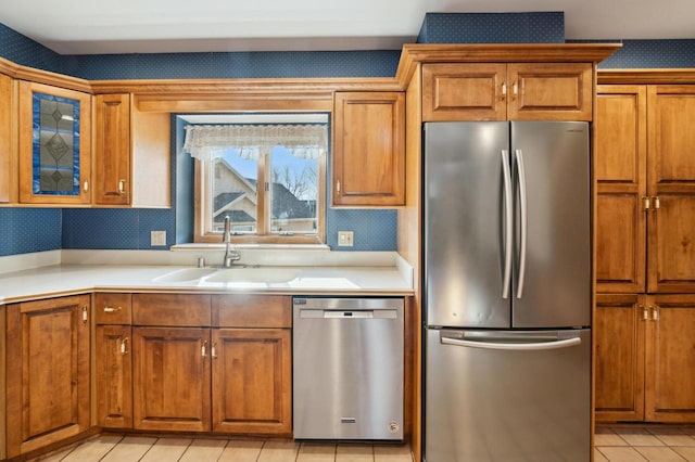 kitchen with sink, light tile patterned flooring, and appliances with stainless steel finishes