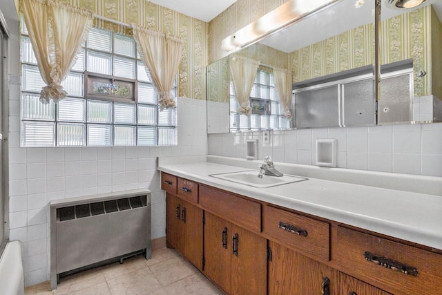 bathroom featuring vanity, radiator heating unit, and tile patterned flooring