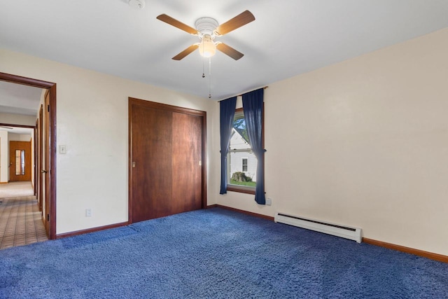 unfurnished bedroom with baseboard heating, carpet, ceiling fan, and a closet