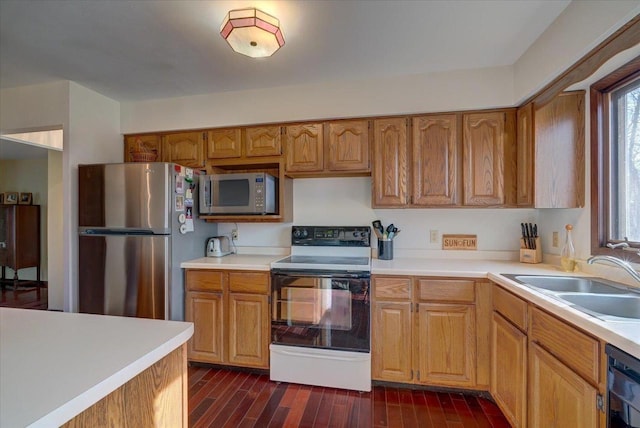 kitchen with sink, dark wood-type flooring, and stainless steel appliances